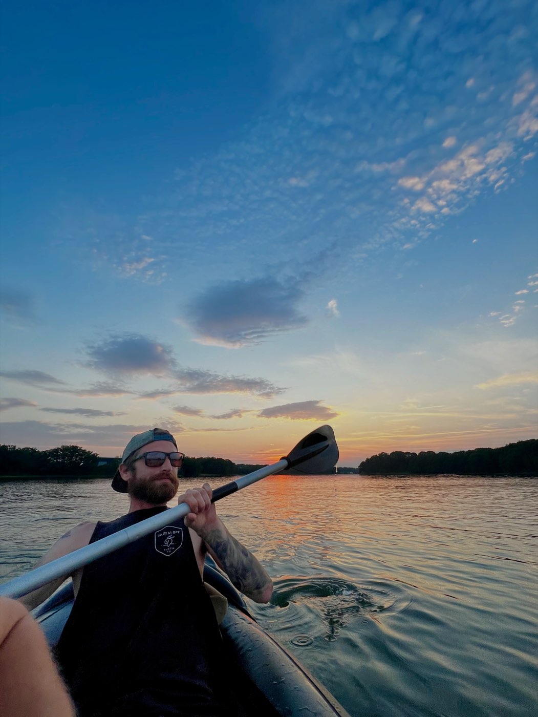 Cody Thibodeau, Lead Carpenter, out on a Maine lake at sunset